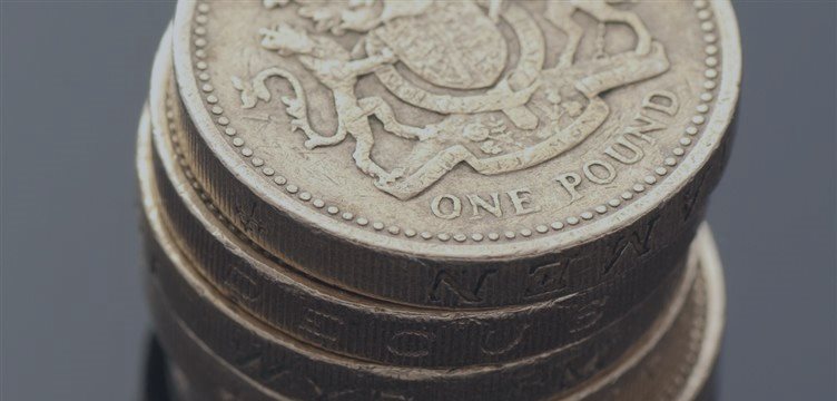 Pound holds flat after strong UK manufacturing data